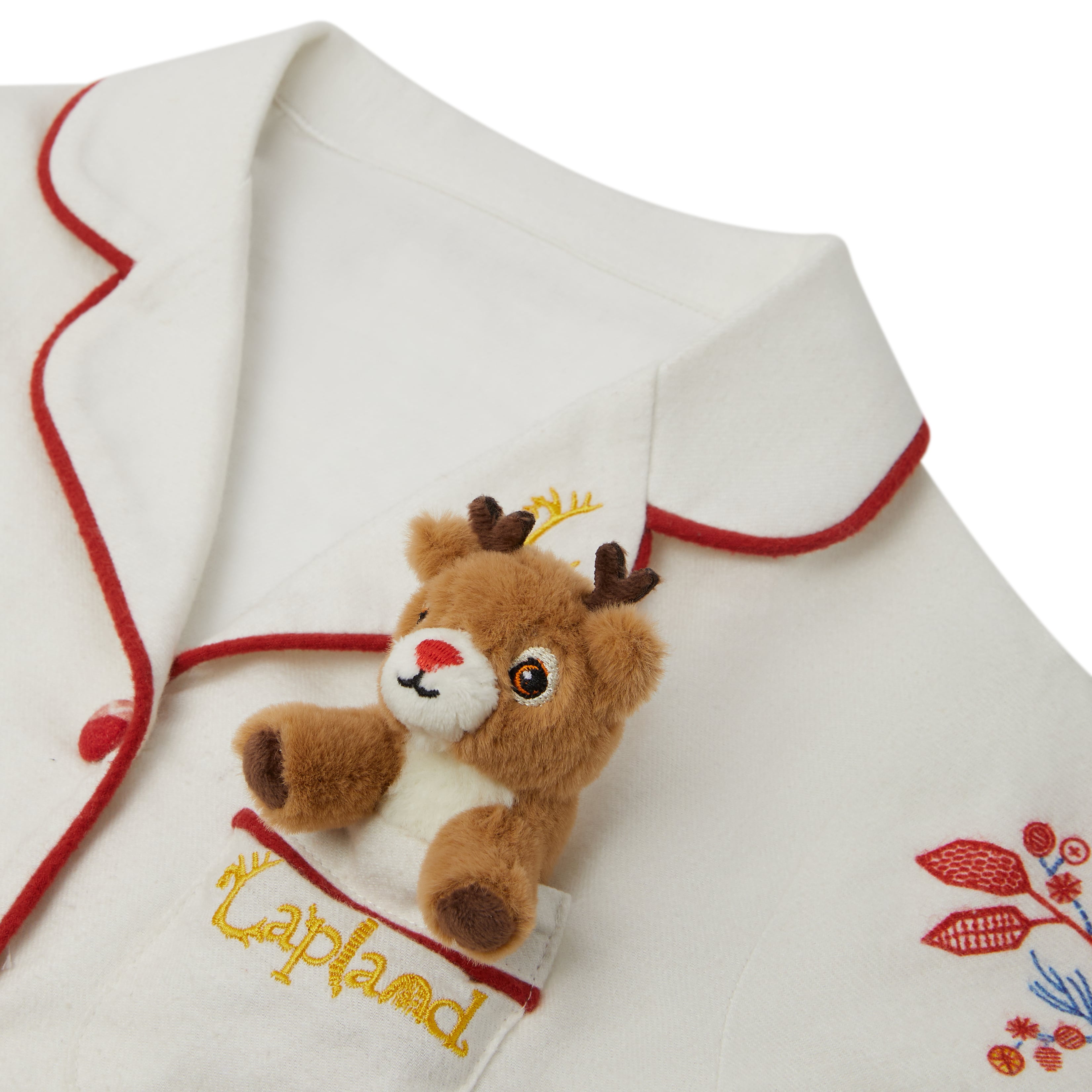 Close-up of a Small Folk Pyjamas top, with red trim, featuring a small plush brown reindeer attached near the chest pocket area and embroidered red floral details on the lower right.