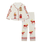 A two-piece children's Small Folk Pyjamas  set featuring a long-sleeve button-front top and matching pants. The pajamas are off-white with red trim and printed with red reindeer, red folk figures, and small blue script names.